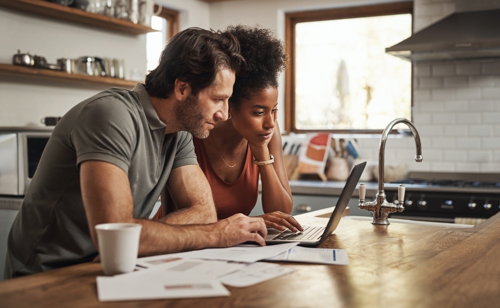 Man and wife applying for a loan to pay off tax debt 