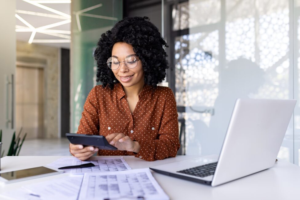 Woman calculating her income to determine if she has to file taxes or not