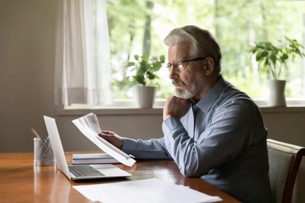 Man reviewing tax documents for retirement income