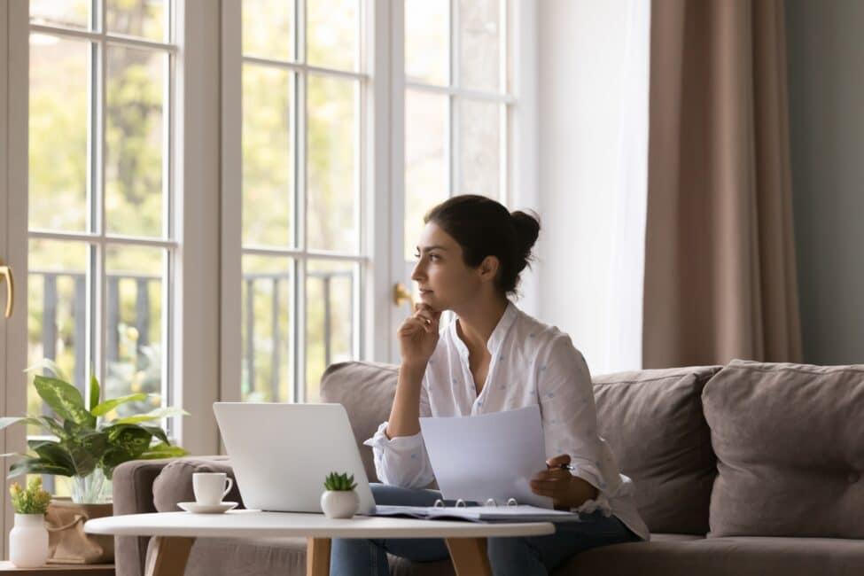 Young Indian woman thinking about getting a personal loan to build credit