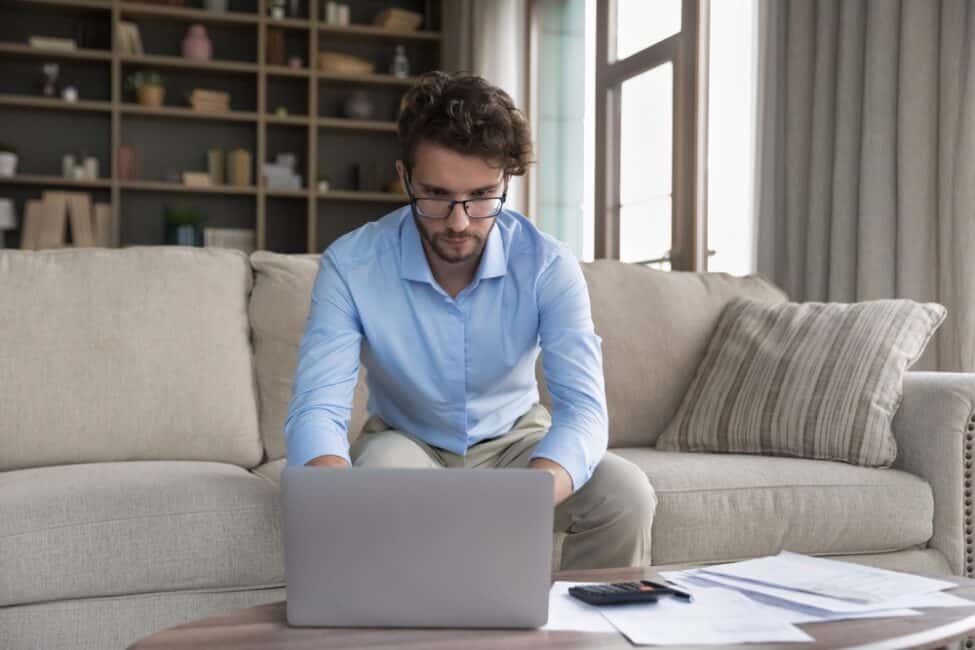 Young man researching alternatives to personal loans for improving credit 