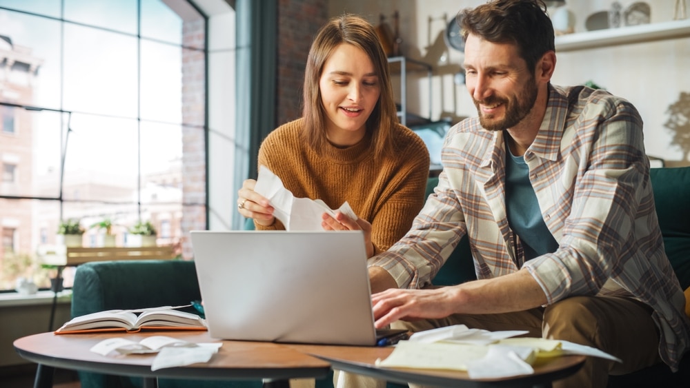 Happy couple claiming different tax credits to reduce their tax burden 