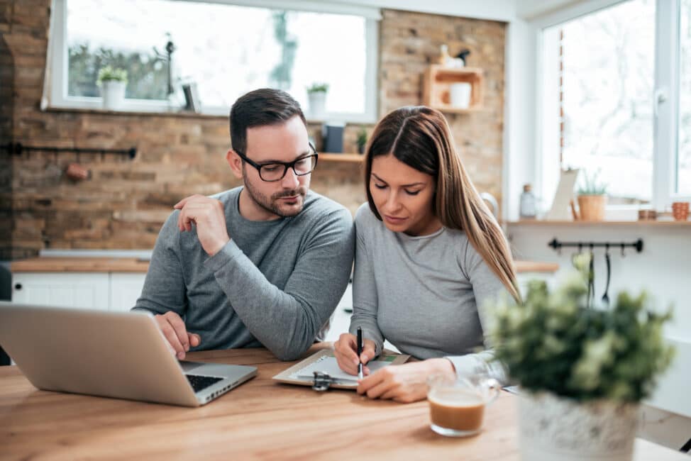 Couple doing calculations to determine whether they need to file state taxes