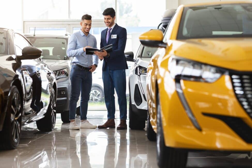 Car dealer talking to potential buyer about buying or leasing a car