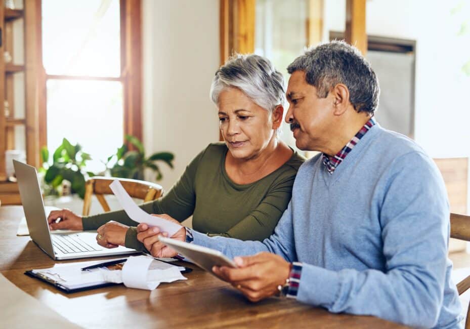 Senior couple calculating finances to determine if debt consolidation is a good idea