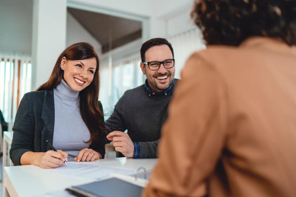 Couple signing loan agreement at the bank